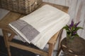 Folded White Towel with Black Herringbone Design on Square Sidetable