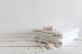 Folded white towels and different seashells on a white wooden table. Spa and wellness, cotton terry textile. Ecological Royalty Free Stock Photo