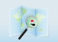 A folded world map with a magnifying lens pointing towards Iraq. Map and flag of Italy in loupe