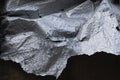 Metallic tarp folded and wrinkled on black background Royalty Free Stock Photo