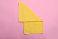 Folded yellow beach towel on pink background, top view Royalty Free Stock Photo