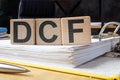 Folder and cubes with letters DCF Discounted Cash Flow.