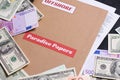 Folder with Paradise papers label on it with european and american currency, offshore tax heave