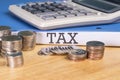 Folder Tax documents and stack of coin with calculator concept Annual tax payment Royalty Free Stock Photo