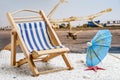 Folding chair on the beack Royalty Free Stock Photo