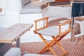 Folding chair made of wood stands on deck ship or yacht