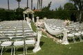 Outdoor wedding white chairs , bridal party