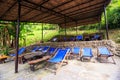 Folding Chairs on Stone Platform under Reed Roof in Park Royalty Free Stock Photo