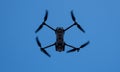 Folding drone taking aerial images from the blue sky Royalty Free Stock Photo