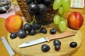 Folding knife and fresh organic ripe fruits peaches grape natural gourmet product dessert Royalty Free Stock Photo
