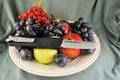 Pocket folding knife and fresh organic ripe fruits apples grape plums berries natural gourmet product dessert background