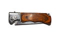 Folding switchblade knife with a button.Switchblade knife on a white background.Folding knife with wooden handle. Royalty Free Stock Photo