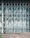 Folding metal gate with lock and zinc reparing of the building