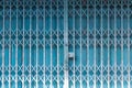 Folding metal house door, Old metallic, Iron door. Blue stretched slide steel airy door at outside with steel sheet lock and dense Royalty Free Stock Photo