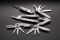 Folding multitools and knives on a dark background. Metal pocket multi-tools