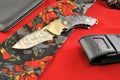 Folding knife black case wallet man tie red background