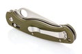Folding pocket knife with closed blade and textured dark green composite plastic cover plates on steel handle isolated on white Royalty Free Stock Photo