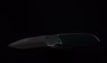 Folding pocket knife isolated on a black background Royalty Free Stock Photo