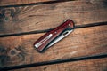 Folding pocket knife with wooden handle. A small knife on a wooden surface Royalty Free Stock Photo