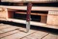 Folding pocket knife with wooden handle. A small knife on a wooden surface Royalty Free Stock Photo
