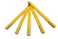 Folding ruler isolated, yellow carpenter`s rule with centimeters numbers. Royalty Free Stock Photo