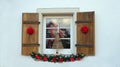 A folding shutters on the window with Christmas decorations