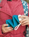 Folding silicone bottle in hand of little girl in red jacket