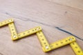 Folding zig zag ruler. Measuring tape folding yellow open in zigzag tips on a workbench. Measuring tools for carpenters and Royalty Free Stock Photo