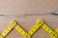 Folding zig zag ruler. Measuring tape folding yellow open in zigzag tips on a workbench. Measuring tools for carpenters and Royalty Free Stock Photo