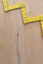 Folding zig zag ruler. Measuring tape folding yellow open in zigzag tips on a workbench. Measuring tools for carpenters and Royalty Free Stock Photo