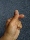 Folds of fingers that have the meaning of love for others. Against a gray carpet background. Royalty Free Stock Photo