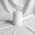 Folds, highlighting the candle\'s simple design. The setting is Royalty Free Stock Photo