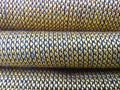 Golden yellow mat stack background. coarse and stiff textured fabric folds