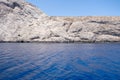 Folegandros island, Vorina bay, Cyclades, Greece. High cliff, Aegean ripple sea, clear blue sky