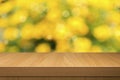 Foliage bokeh background with empty wooden table. Royalty Free Stock Photo