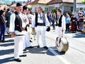 Folk artists performing folk music at Novaci Romania in national pastoral costumes made of linen cloth sewn with traditional black