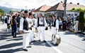 Folk artists performing folk music at Novaci Romania in national pastoral costumes made of linen cloth sewn with traditional black