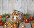 Folk medicine.Glass storage jar with medicinal dried red flowers of black marigolds on a wooden background.The benefits of Royalty Free Stock Photo