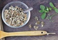 Folk medicine, Moringa seeds, dried in clear glass cups, empty letters, wooden floor, leaves background,