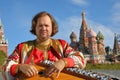 Minstrel playing an old Russian musical instrument gusli Royalty Free Stock Photo