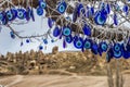 Folk Turkish talismans from the evil eye are hung over the trees in the Cappadocia