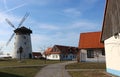 Folklore colony with an old windmill with blue sky above