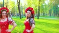 Folklore dance by ukrainian women in bright costumes and flower circlets