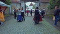Folklore dancers performing on street with accordeon player