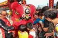 Folks getting goodies from lion dance ritual