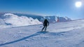 FOLLOW: Cool snowboarder girl carving down a ski slope on a sunny winter day.