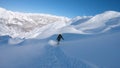 FOLLOW: Cool woman rides her snowboard down a mountain covered in fresh snow.