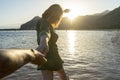 Follow of girlfriend in a summer dress running and holding boyfriend hand on the beach in sunset. Happy couple in honeymoon, Royalty Free Stock Photo