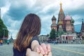 Follow me, brunette girl holding the hand leads to the red square in Moscow. Russia.