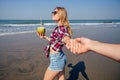 Follow me concept. girlfriend leading man holding hand. Happy woman holding coconut. Couple in love walking on tropical Royalty Free Stock Photo